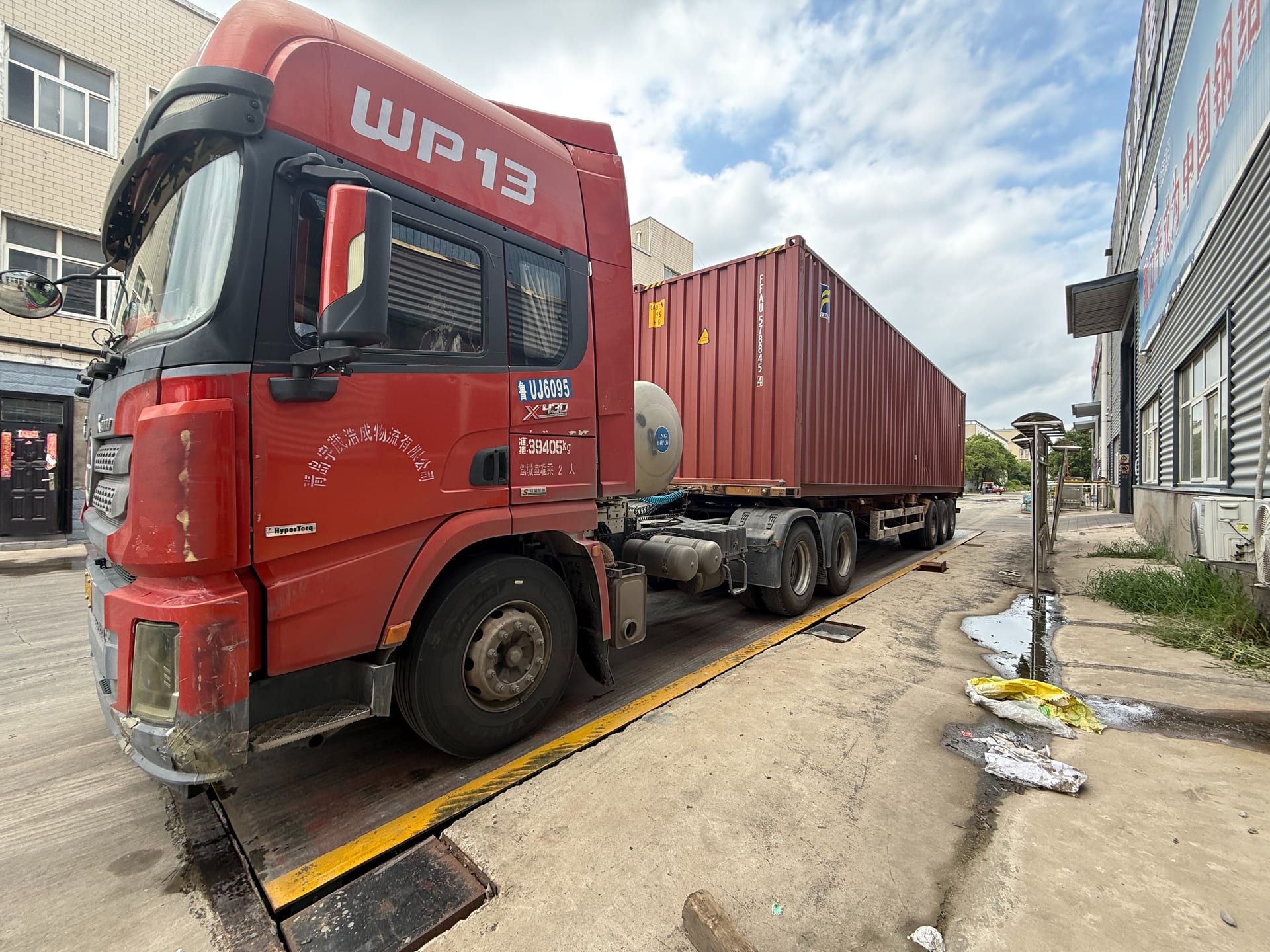 Shipping container positioned for steel structure export loading